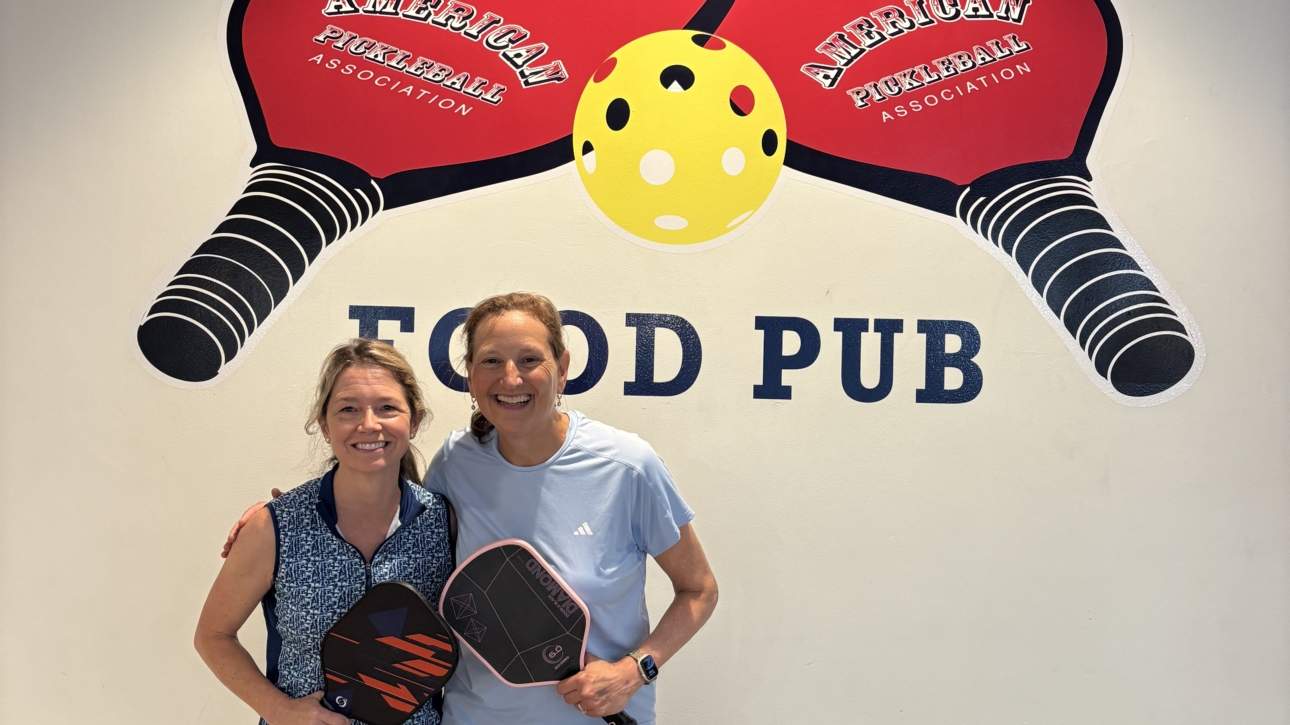 Cheerful pickleball players holding paddles