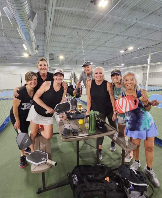 a group of p[eople smiling at the Pickleball Food Pub in Colorado