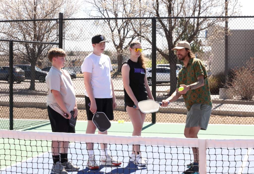 An image of a pickleball pro giving a lesson.