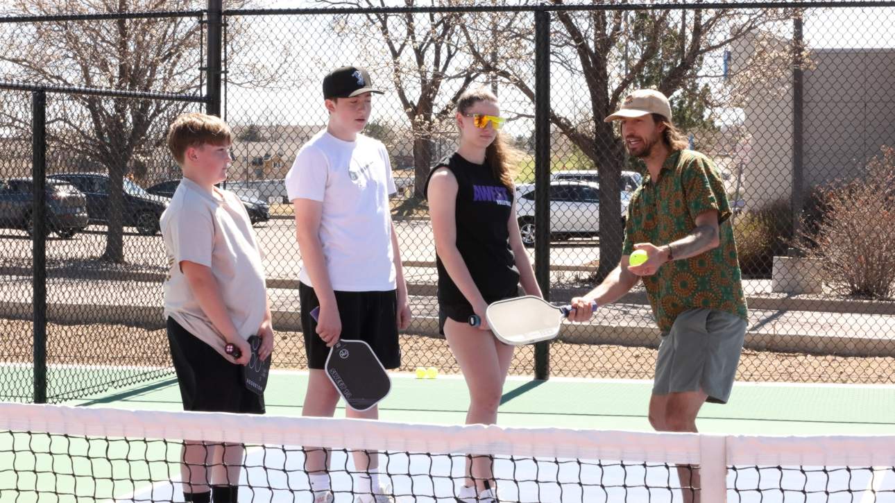 An image of a pickleball pro giving a lesson.