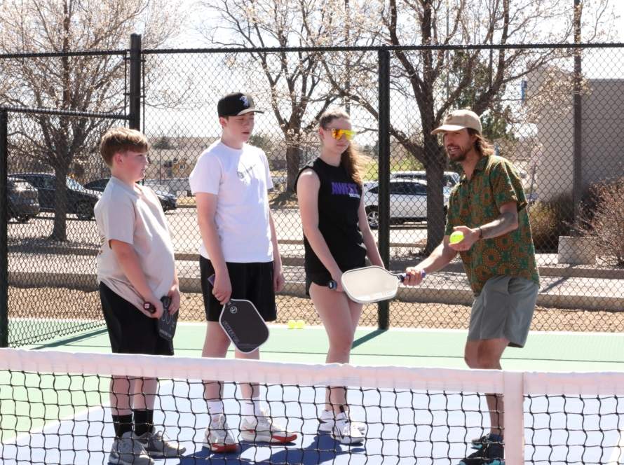 An image of a pickleball pro giving a lesson.